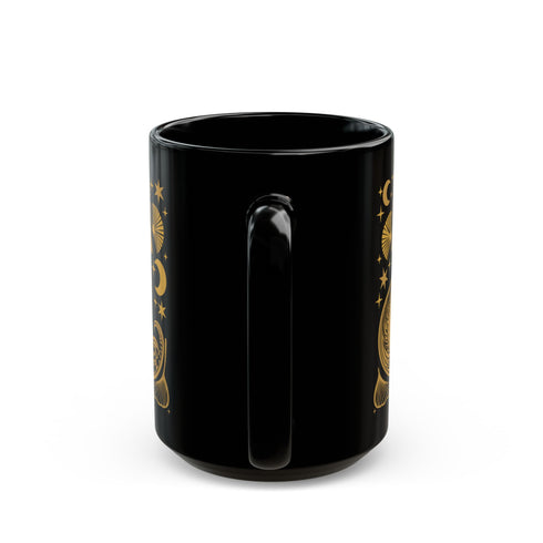 A black ceramic mug featuring a stylized golden fox design surrounded by Art Deco ginkgo fans, crescent moons, and stars. The mug has a glossy finish and ergonomic handle.
